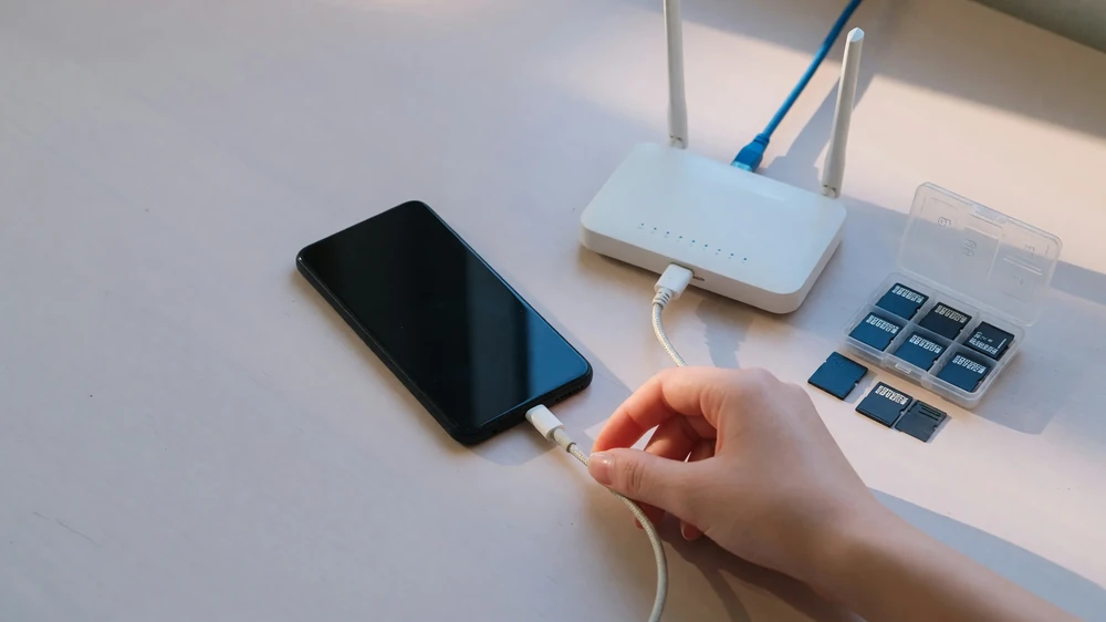 Phone charging beside a router during download prep